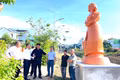 Delegates visit a newly completed artwork on display during the second phase of the exhibition. Photo: Lam Nguyen