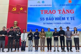 Coordinating units present health insurance cards to disadvantaged residents in the western region of the province.