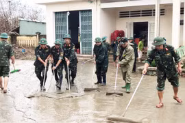 Soldiers waded through thick mud to help residents clean up and rebuild homes and schools in the aftermath of the historic flood.
