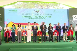 Delegates cut the ribbon at the inauguration of the Yăng Village School, funded by the Cargill Cares Foundation. Photo: R'Piên