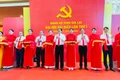 The delegates cut the ribbon to open the photo exhibition titled "Gia Lai Provincial Party Committee—Proudly Continuing the Glorious Tradition." Photo: Trần Dung