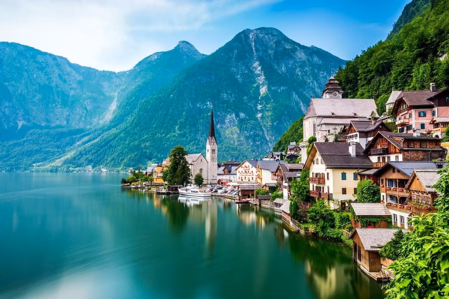 Tucked between lush mountain peaks and the shimmering Hallstatt Lake, this Austrian village dazzles like a fairytale reflection.