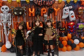 Children excitedly dress up in costumes and take photos at the Halloween Festival.
