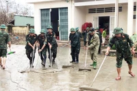 Soldiers waded through thick mud to help residents clean up and rebuild homes and schools in the aftermath of the historic flood.