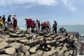 Tourists visit Ghenh Da Dia, a natural rock formation in Tuy An Dong Commune, Dak Lak Province.