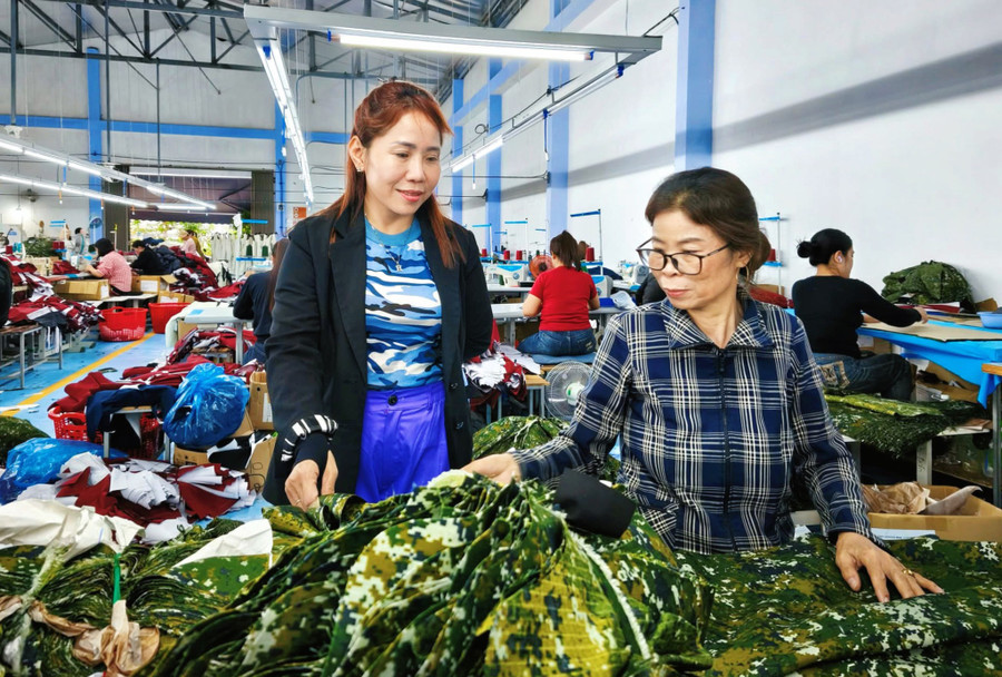 Ms. Nguyễn Thị Kim Hân (left, from Phú Xuân quarter, Tây Sơn commune) instructs female workers at her garment facility. Photo: Hải Yến ho-tro-phu-nu.jpg