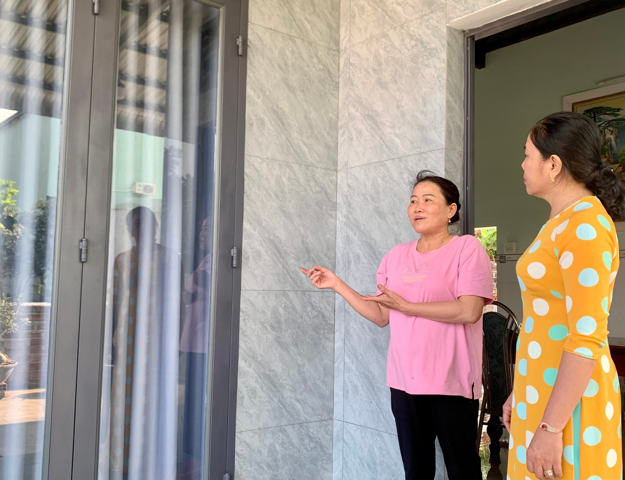 Ms. Vân (left) in her new, spacious home. Photo: Thảo Khuy suc-khoe-chi-van-ben-trong-ngay-cang-tot-nho-co-ngoi-nha-khang-trang.jpg