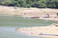 Residents of Canh Tiến village primarily travel by boat or canoe across Nui Mot Lake to reach An Nhon Tay commune.