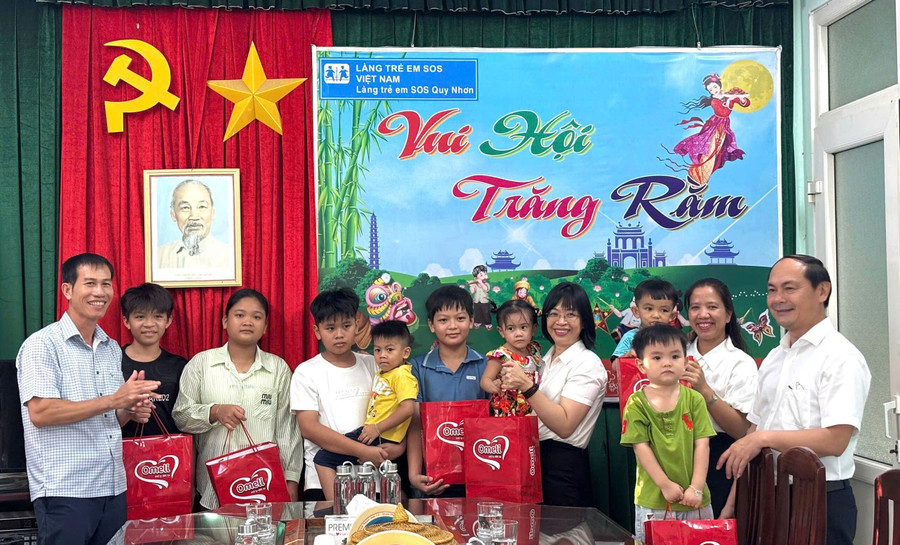 Vice Chairwoman of the Provincial People's Committee Nguyễn Thị Thanh Lịch (fifth from the right) presents gifts to children at SOS Children's Village Quy Nhơn (Quy Nhơn Đông Ward). Photo: Đoàn Bình tang-qua-tet-trung-thu-cho-tre-em-co-hoan-canh-dac-biet-kho-khan.jpg