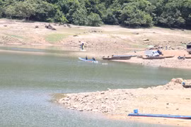 Residents of Canh Tiến village primarily travel by boat or canoe across Nui Mot Lake to reach An Nhon Tay commune.