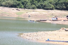 Residents of Canh Tiến village primarily travel by boat or canoe across Nui Mot Lake to reach An Nhon Tay commune.