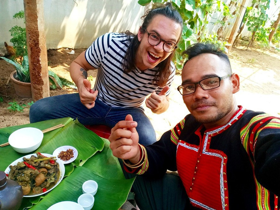Rcom Dam Mơ Ai (far right) guides photographer and filmmaker Stephen Parcalidis in preparing and enjoying Jrai cuisine. Photo: Rcom Dam Mơ Ai 7.jpg