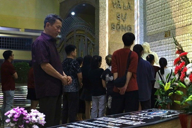 After attending Mass in the sanctuary, many parishioners lingered in the church grounds to pray for the souls of the departed.