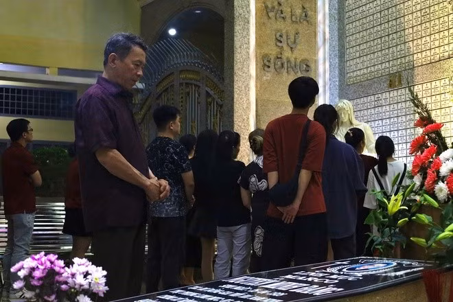 After attending Mass in the sanctuary, many parishioners lingered in the church grounds to pray for the souls of the departed.
