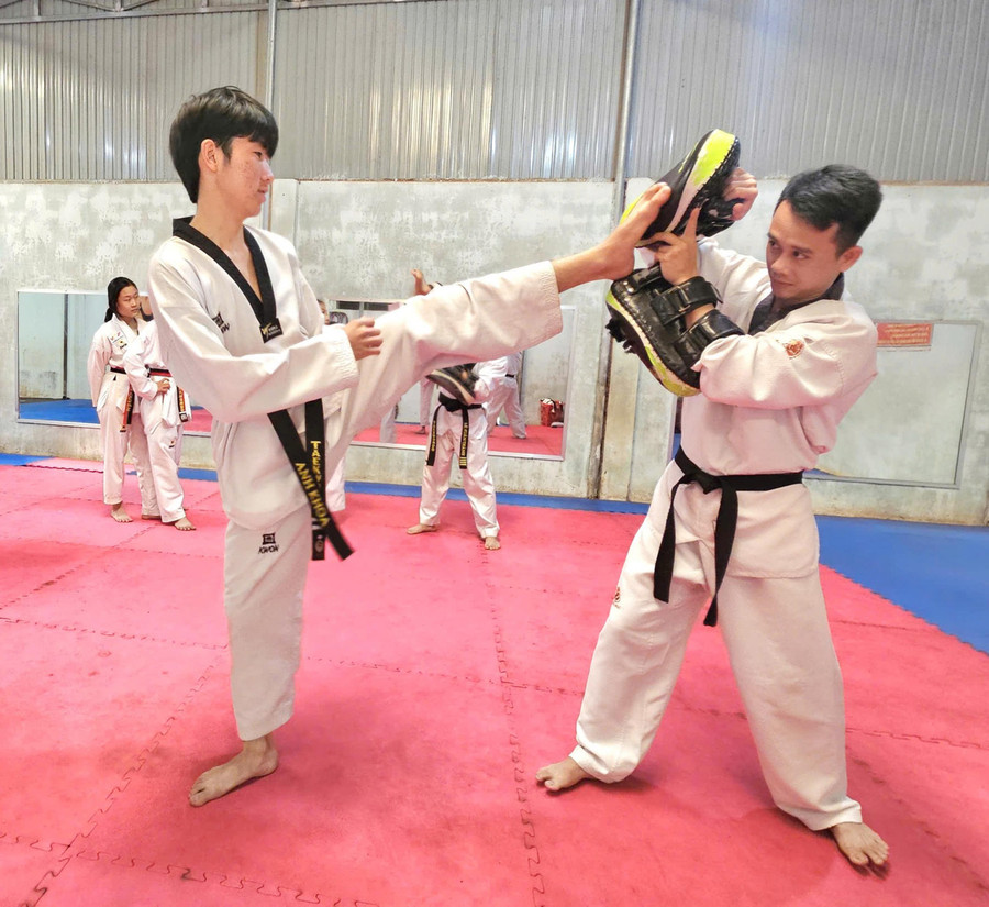 Coach Cao Văn Thảo (right) instructs his students during training. Photo: R’Ô HOK