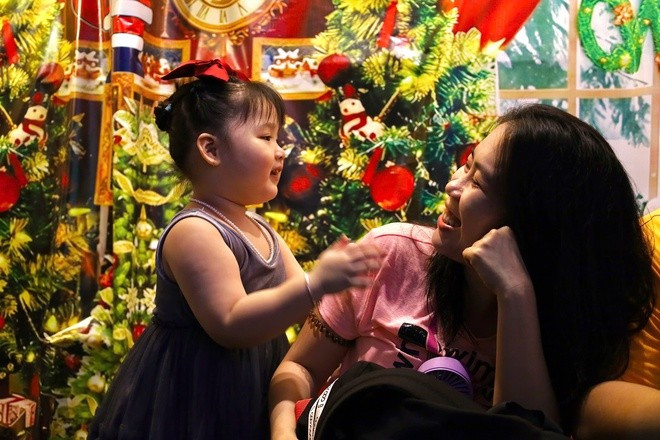 Children taking photos with their families.