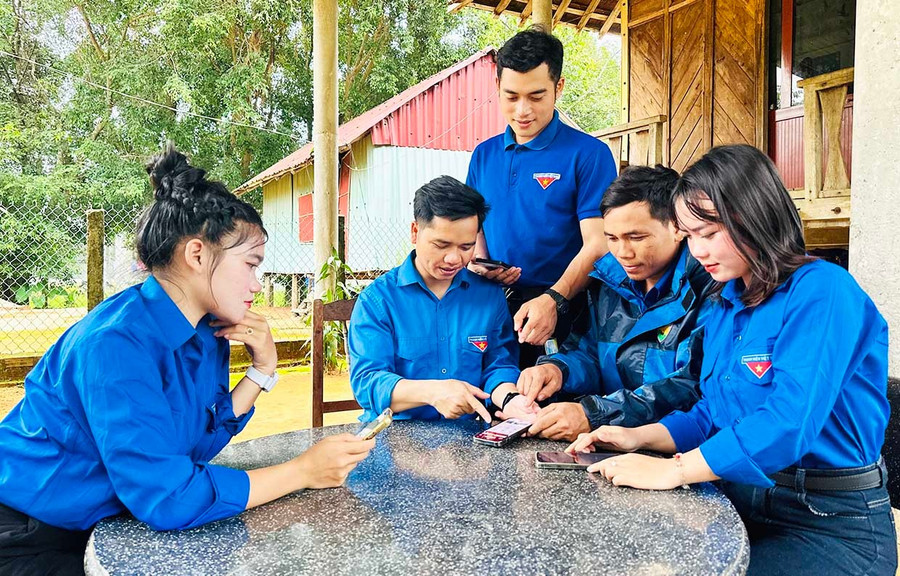 Tổ công nghệ số thanh niên xã Canh Liên hướng dẫn người dân làng Kà Bông cài đặt và sử dụng ứng dụng VNeID trên điện thoại.