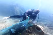 Members of the Nhon Hai Community Group for Aquatic Resource Protection dive to safeguard the coral reefs.